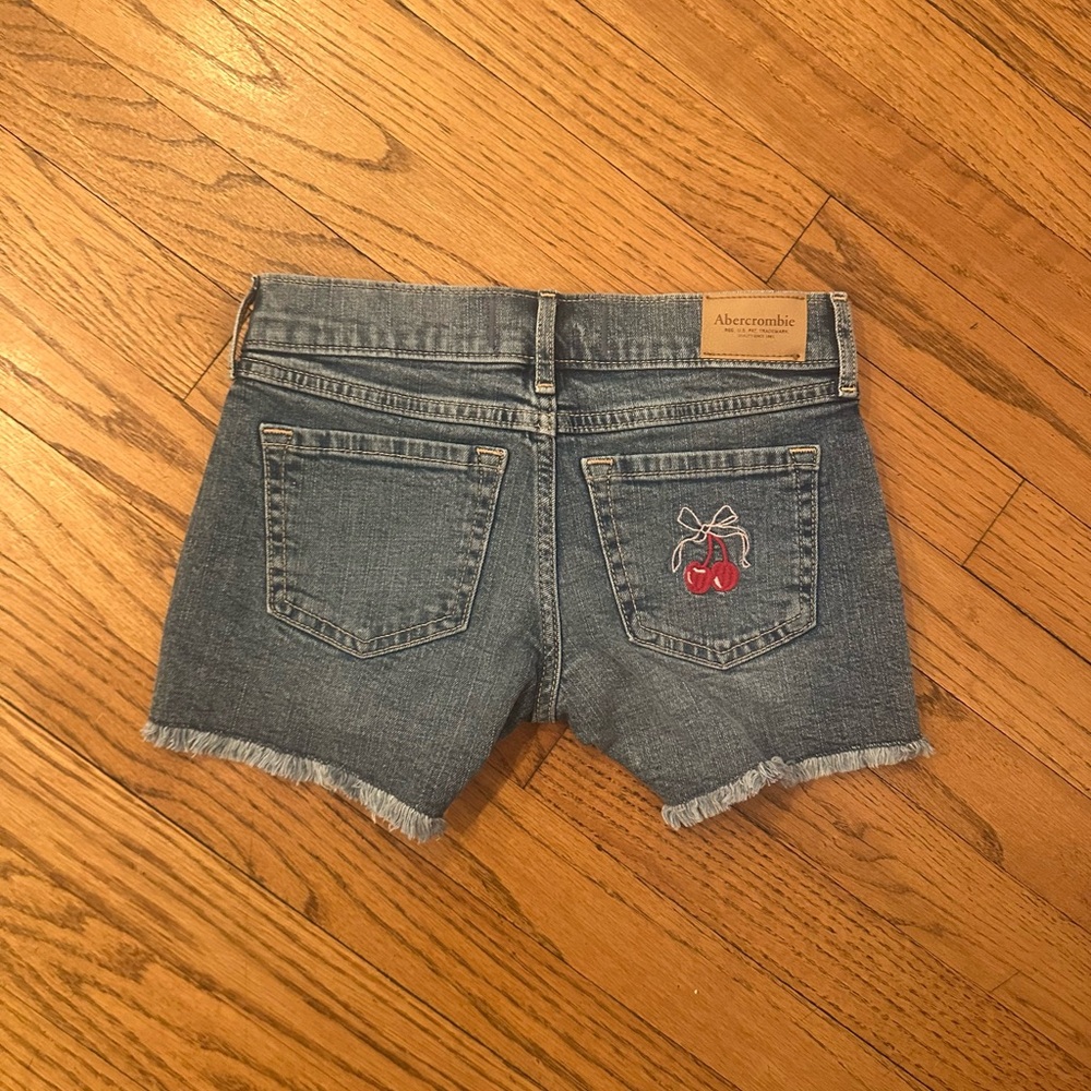 Girls Abercrombie Kids Blue Low Rise Midi Shorts with cherry embroidery